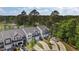 Birds eye view displays several townhomes with driveways and parked vehicles surrounded by trees and lawns at 124 Myatt Fern Dr, Garner, NC 27529