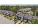 Overhead shot showcases a row of townhomes with manicured lawns, driveways, and a nearby apartment complex at 124 Myatt Fern Dr, Garner, NC 27529