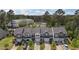 Aerial photo shows multiple townhomes with garages, landscaping, and parked cars against a wooded backdrop at 124 Myatt Fern Dr, Garner, NC 27529