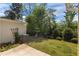 Backyard with small patio, green grass, mature trees, and foliage at 124 Myatt Fern Dr, Garner, NC 27529