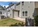 View of the home's backyard featuring green grass, an AC unit, a small patio and exterior features at 124 Myatt Fern Dr, Garner, NC 27529