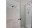 Bright bathroom featuring a glass shower with modern fixtures and the bedroom with fan can be seen in the background at 124 Myatt Fern Dr, Garner, NC 27529