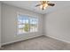 Comfortable bedroom with carpet, natural lighting and a ceiling fan perfect for anyone looking to relax and unwind at 124 Myatt Fern Dr, Garner, NC 27529