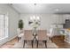 Bright dining room with glass table, chandelier, and stylish decor at 124 Myatt Fern Dr, Garner, NC 27529