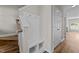 Hallway featuring wood floors and a charming mudroom bench near the staircase at 124 Myatt Fern Dr, Garner, NC 27529