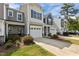 Attractive townhome with well-kept landscaping, attached garage, and a welcoming walkway at 124 Myatt Fern Dr, Garner, NC 27529