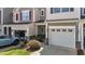 Exterior view features garages, colorful shutters, stone accents, and manicured landscaping at 124 Myatt Fern Dr, Garner, NC 27529