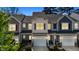 Charming townhome with a well-manicured lawn, attached garages, and inviting curb appeal at 124 Myatt Fern Dr, Garner, NC 27529