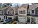 Townhome's exterior view with attached garages, decorative shutters, and well-kept landscaping at 124 Myatt Fern Dr, Garner, NC 27529