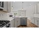 Kitchen island with dishwasher and view of open living space with fireplace at 124 Myatt Fern Dr, Garner, NC 27529