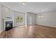 Bright living room featuring hardwood floors, a fireplace, and natural light at 124 Myatt Fern Dr, Garner, NC 27529