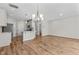 Open-concept living area with hardwood floors and modern lighting at 124 Myatt Fern Dr, Garner, NC 27529