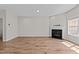 Spacious living room with a cozy fireplace and large window allowing natural light at 124 Myatt Fern Dr, Garner, NC 27529
