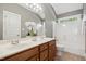 Bathroom with double sink vanity, white countertops, and tub and shower combo at 12428 Penrose Trl, Raleigh, NC 27614