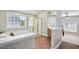 Bright bathroom with soaking tub and shower with tile flooring and window at 12428 Penrose Trl, Raleigh, NC 27614