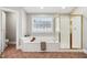 Spacious bathroom features a large tub, shower, and neutral color palette at 12428 Penrose Trl, Raleigh, NC 27614