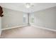Neutral bedroom featuring two windows, carpet, and floating shelves at 12428 Penrose Trl, Raleigh, NC 27614