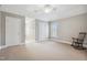 Spacious bedroom with a ceiling fan, rocking chair, and two separate closets at 12428 Penrose Trl, Raleigh, NC 27614