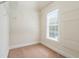 Walk-in closet with installed shelving and a window for natural light at 12428 Penrose Trl, Raleigh, NC 27614