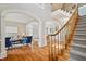 Elegant foyer with staircase, hardwood floors, and arched doorways leading to the living spaces at 12428 Penrose Trl, Raleigh, NC 27614