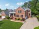Beautiful two-story brick home featuring a landscaped front yard and inviting front porch at 12428 Penrose Trl, Raleigh, NC 27614
