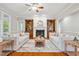 Bright living room boasts a fireplace, custom built-ins, and elegant furnishings, perfect for relaxation and entertaining at 12428 Penrose Trl, Raleigh, NC 27614