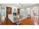 Open-concept living room featuring a fireplace, built-in bookshelves, and hardwood floors, creating a warm and inviting space at 12428 Penrose Trl, Raleigh, NC 27614
