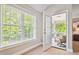 Sitting area featuring a large window and doorway leading to a screened porch at 12428 Penrose Trl, Raleigh, NC 27614