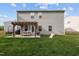 Spacious backyard view with a pergola-covered patio, green lawn, and recreational area with a slide at 1302 Ingle Ct, Burlington, NC 27215