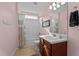 Well-lit bathroom with wooden vanity, shower and tub combination at 1302 Ingle Ct, Burlington, NC 27215