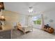 bedroom with pastel wood accent wall, ceiling fan and plush toys at 1302 Ingle Ct, Burlington, NC 27215