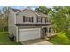Two-story home with vinyl siding, attached two-car garage, and covered front porch at 1302 Ingle Ct, Burlington, NC 27215