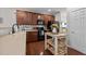 Functional kitchen with dark wood cabinets, black appliances, and eat-in space at 1302 Ingle Ct, Burlington, NC 27215