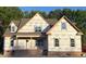 New construction home featuring prominent windows, brick foundation, and protective house wrap for weather resistance at 1589 S Old Carriage Rd, Rocky Mount, NC 27804
