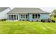 Expansive backyard featuring a well-maintained lawn, a patio, and seamless transitions from indoor to outdoor living at 1601 Garden Park Cir, Fuquay Varina, NC 27526