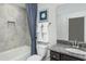 Bathroom with tile accents, patterned shower curtain, and vanity with dark cabinets at 1601 Garden Park Cir, Fuquay Varina, NC 27526