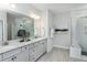 Modern bathroom with double vanity, granite countertops, and a glass-enclosed shower at 1601 Garden Park Cir, Fuquay Varina, NC 27526