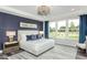 Beautiful bedroom with a large window, tray ceiling, and a luxurious king-size bed at 1601 Garden Park Cir, Fuquay Varina, NC 27526