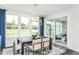 Elegant dining room with a modern chandelier, large windows, and access to outdoor patio at 1601 Garden Park Cir, Fuquay Varina, NC 27526