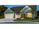 Charming curb appeal with blue siding, a manicured lawn, and convenient two-car garage at 1601 Garden Park Cir, Fuquay Varina, NC 27526