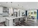 Modern kitchen featuring a large island with seating, stainless steel appliances, and a stylish backsplash at 1601 Garden Park Cir, Fuquay Varina, NC 27526