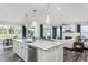 Open-concept kitchen showcasing a spacious island, stainless steel appliances, and seamless flow to the living area at 1601 Garden Park Cir, Fuquay Varina, NC 27526