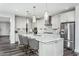 Modern kitchen featuring a large island with seating, stainless steel appliances, and stylish backsplash at 1601 Garden Park Cir, Fuquay Varina, NC 27526