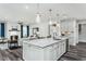 Well-designed kitchen with a large island, stainless steel appliances, and views of the living space at 1601 Garden Park Cir, Fuquay Varina, NC 27526