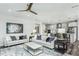 Spacious living area featuring an open layout to the kitchen, modern decor, and comfortable sofas at 1601 Garden Park Cir, Fuquay Varina, NC 27526