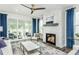 Cozy living room with a fireplace, plush seating, and access to a patio with views at 1601 Garden Park Cir, Fuquay Varina, NC 27526