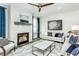 Bright living room featuring a fireplace, modern decor, and comfortable seating arrangements at 1601 Garden Park Cir, Fuquay Varina, NC 27526
