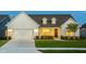 Charming one-story home boasting a pristine lawn, covered porch and attached two-car garage at 1605 Garden Park Cir, Fuquay Varina, NC 27526