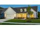 Inviting one-story home with manicured lawn, stylish dormers, and an attached two-car garage at 1605 Garden Park Cir, Fuquay Varina, NC 27526