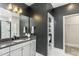 Stylish powder room with dark gray walls, white vanity, and toilet room at 1609 Garden Park Cir, Fuquay Varina, NC 27526